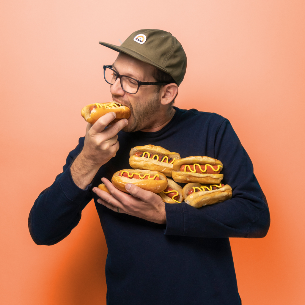 Studio co-founder Josh Kenyon eating hotdogs